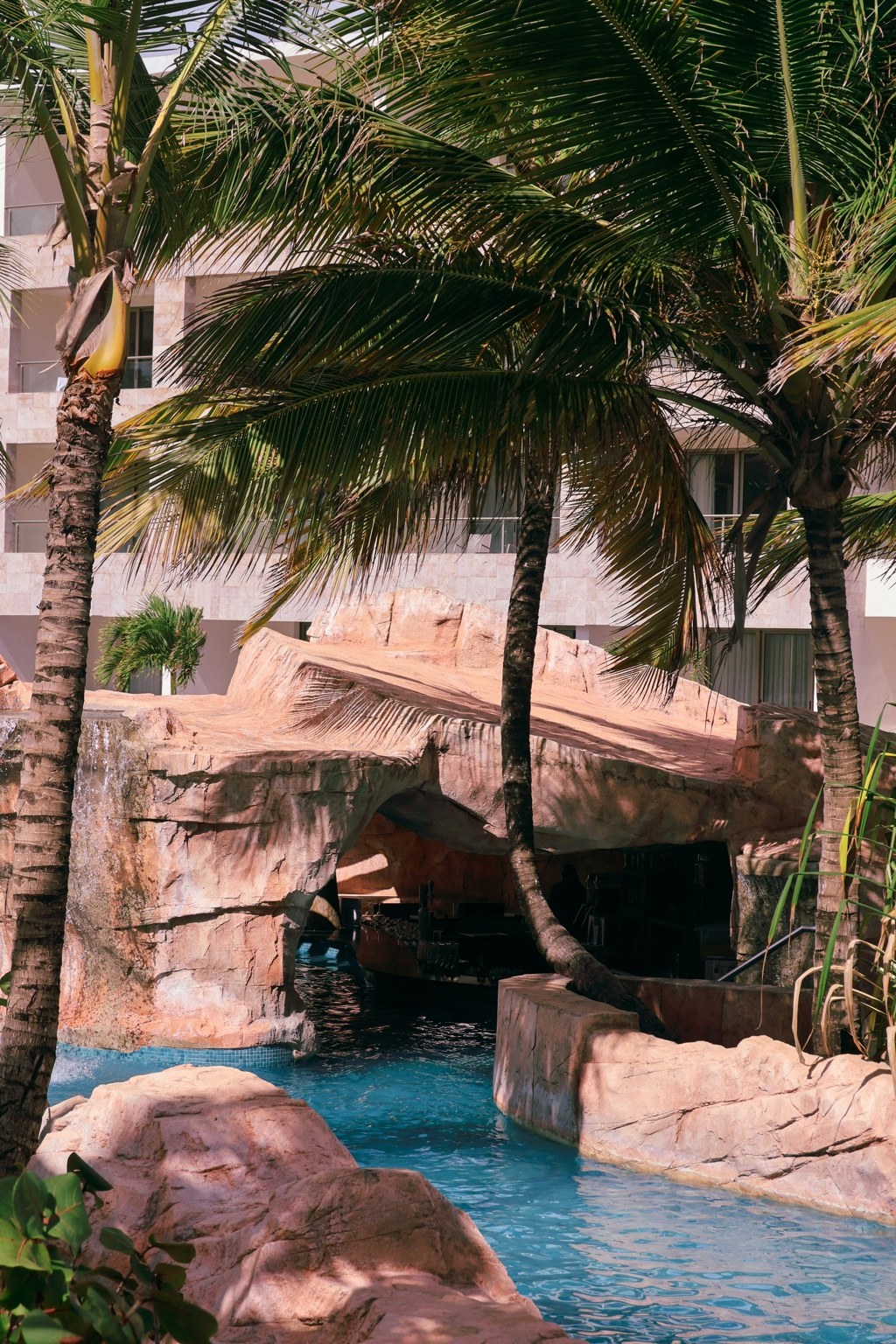 Tropical resort pool and palms in Bávaro, Dominican Republic