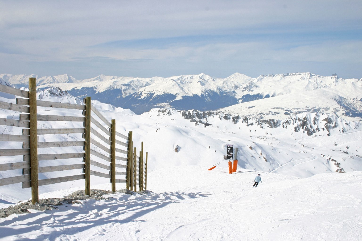 Skier overlooking a panoramic European Alps landscape