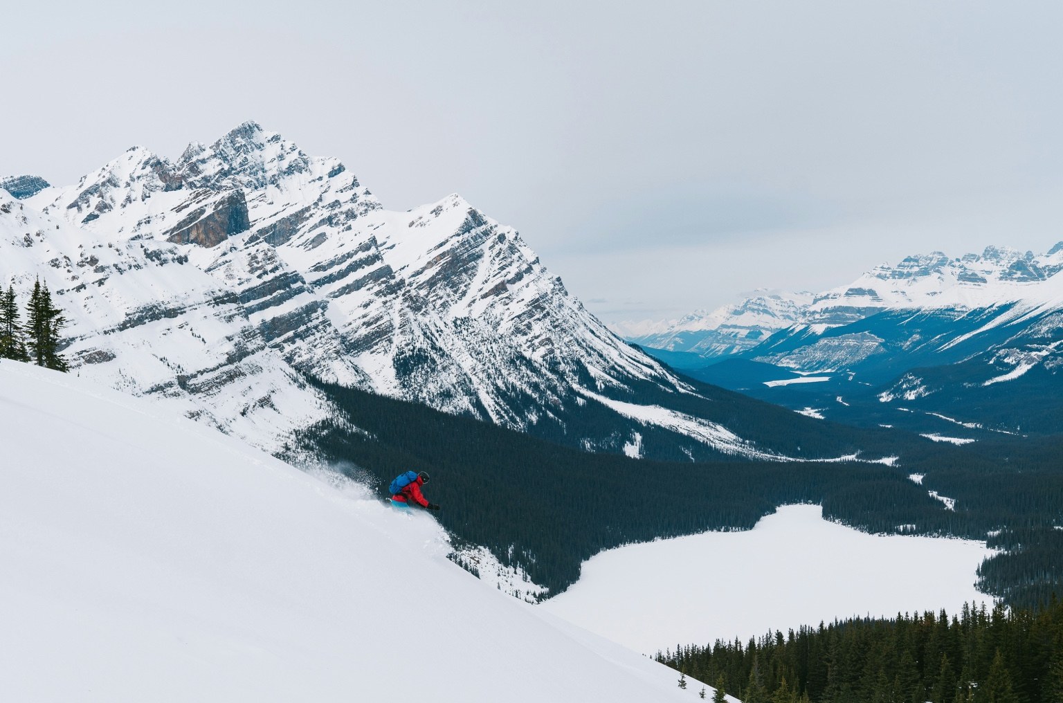 Skier overlooking the snow-covered Canadian Rockies